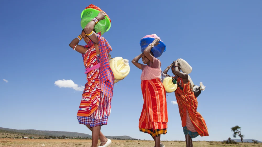 Masai women carrying water