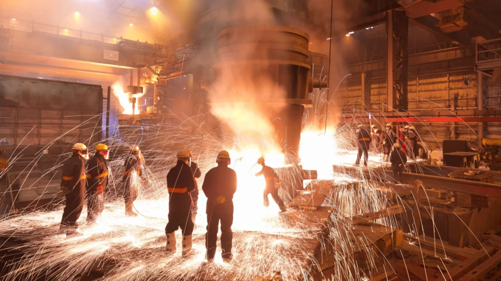 Workers in a molten steel plant. Sheffield, UK
