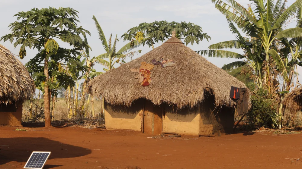 Ugandan village house with solar panel. Philippe Lissac / Godong / Getty Images.