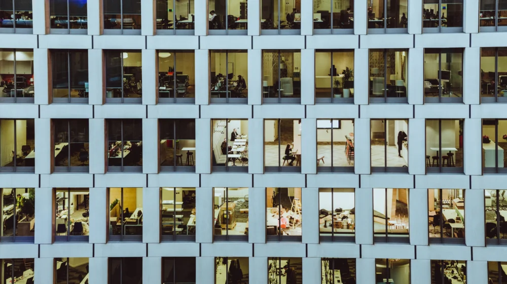 People inside a high-rise building with concrete walls.