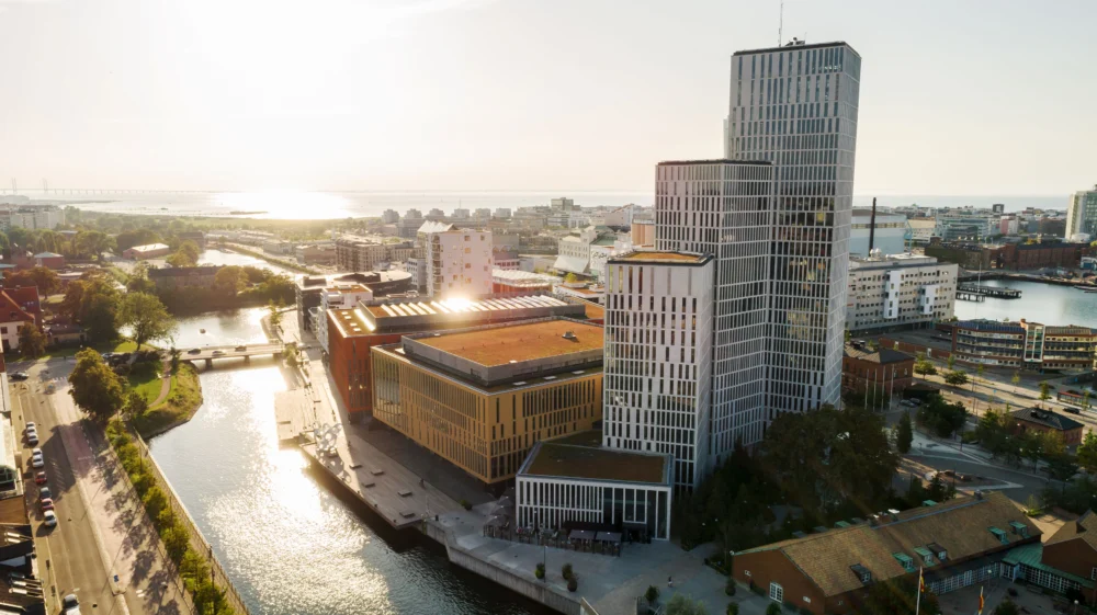 Aerial view of a modern high-rise building in a large city by the sea. Malmö Live is a neighborhood with concert halls, hotels and residences.