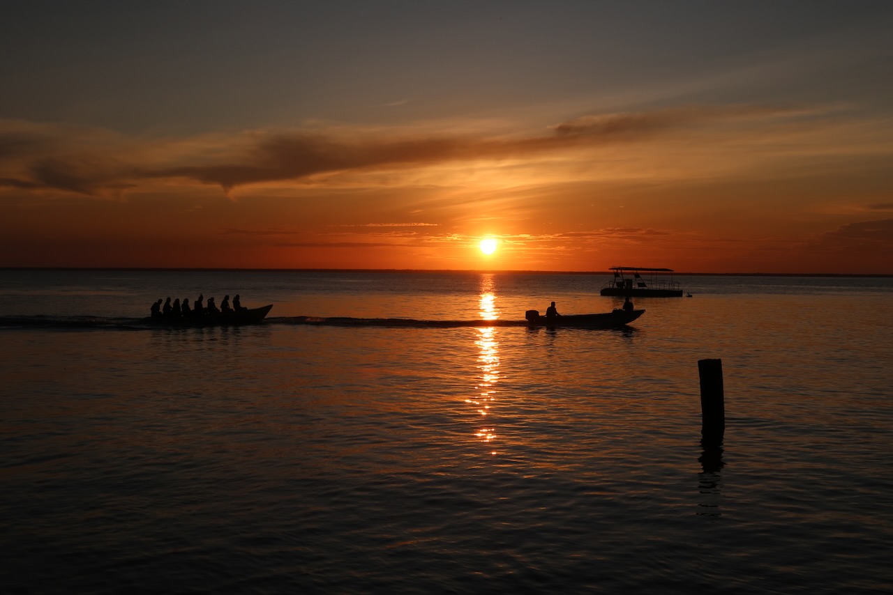 sunset on a river with boats...