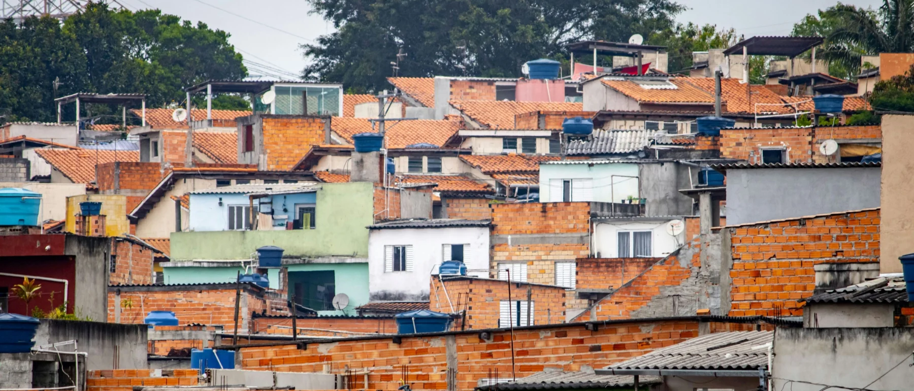 Aerial view of rust-colored rooftops beneath a gray sky in São Paulo, Brazil.