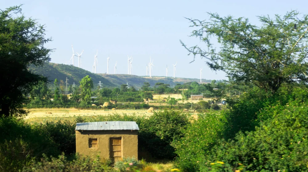 A house in Nazret, Ethiopia with wind turbines in the background.