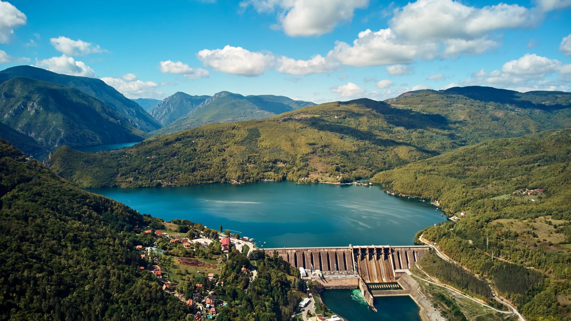 Drone aerial footage of river Drina and Tara mountain hilly landscape in Serbia. Electric power plant Bajina Basta.