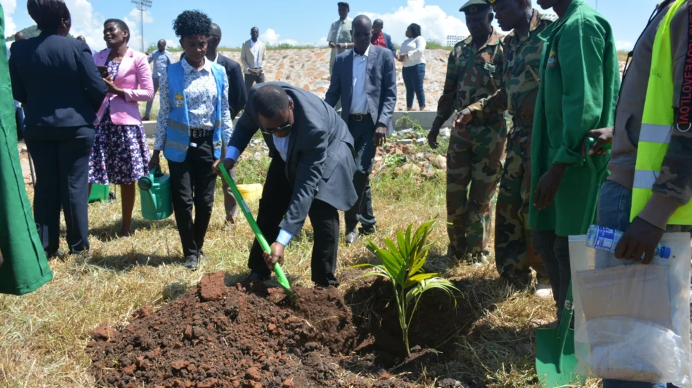 Philip Osano plants a commemorative tree at the Raila Amolo Odinga stadium in Homa Bay County, Kenya