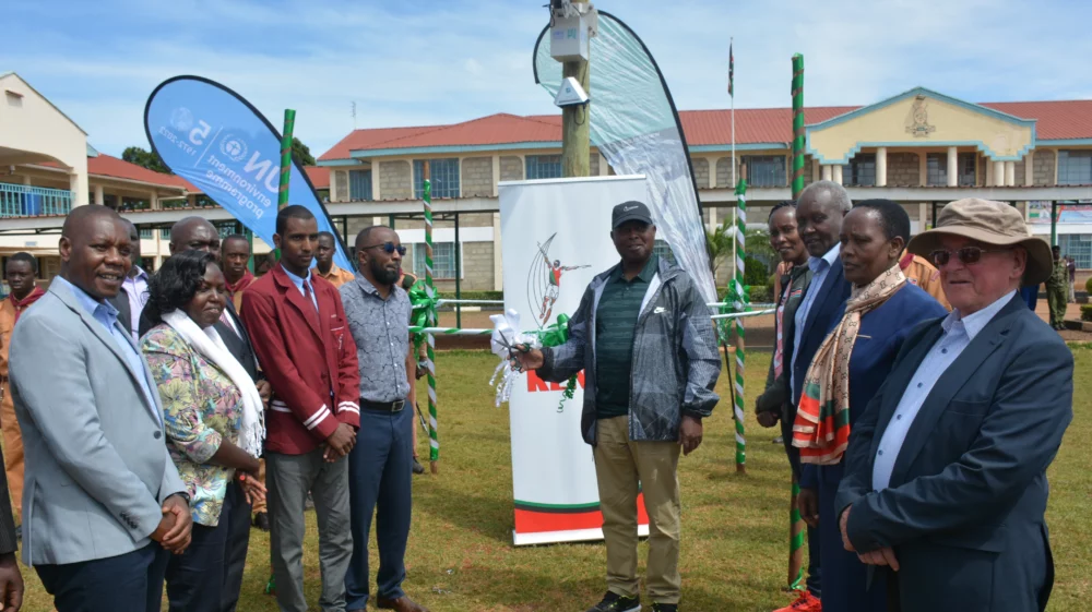 Philip Osano and Lt Gen Rtd Jackson Tuwei cut a ribbon at launch event at a school in Iten, Kenya.