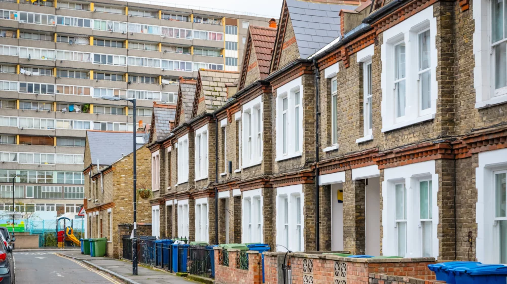 Traditional English terraced houses with huge council block in the background
