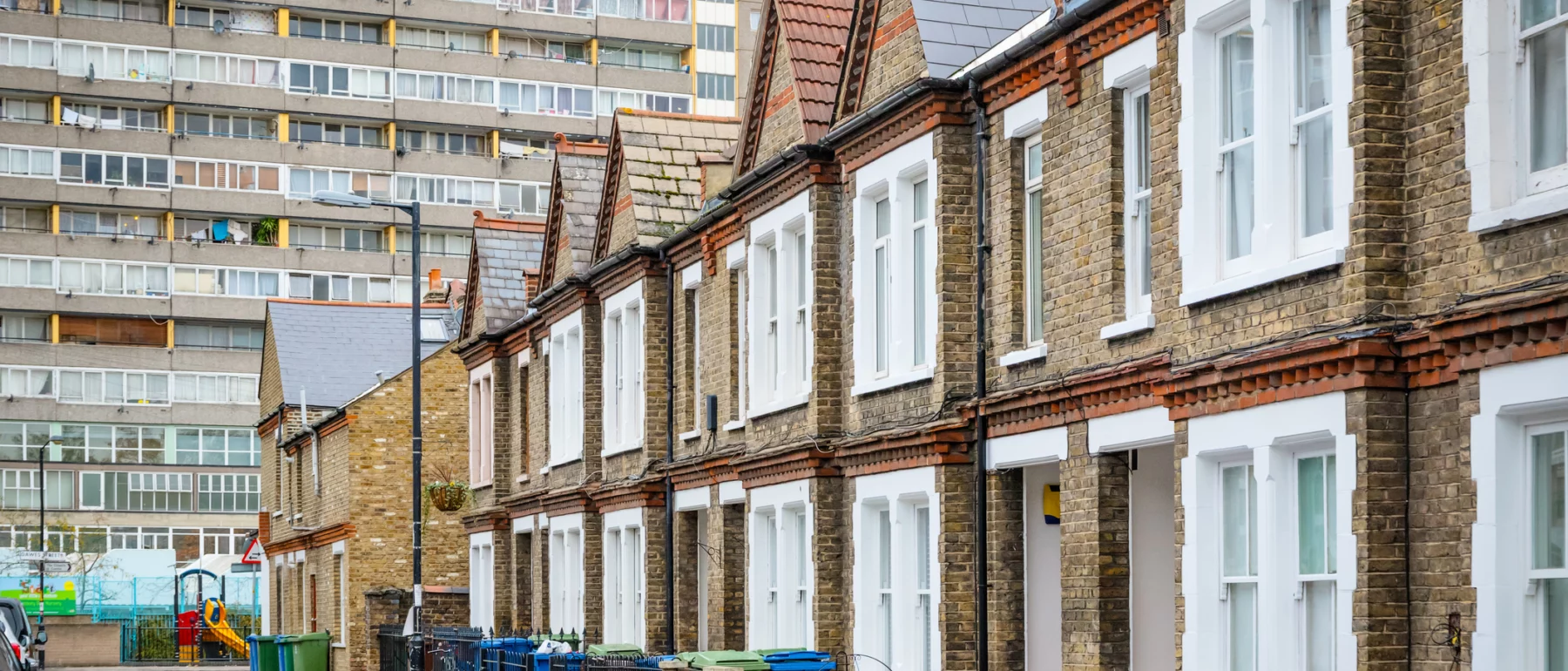 Traditional English terraced houses with huge council block in the background