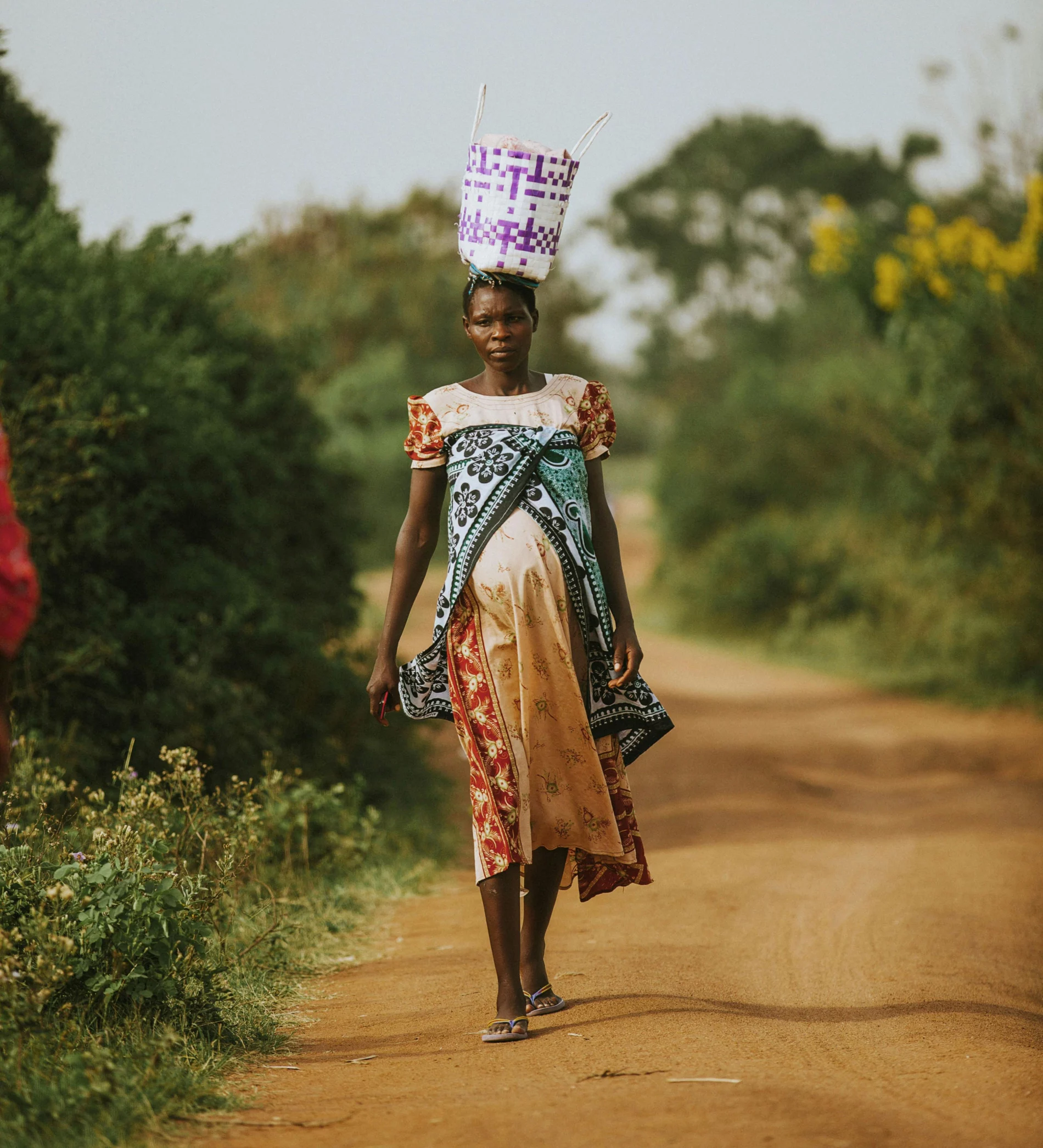Expectant African woman coming from the market