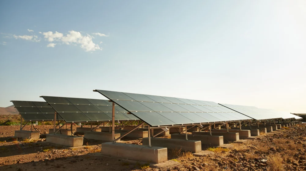 Shot of a row of solar panels basking in the sun to generate electricity for the nearby holiday resort.