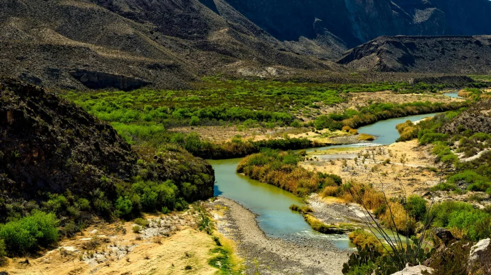 A stream of water cuts through a valley