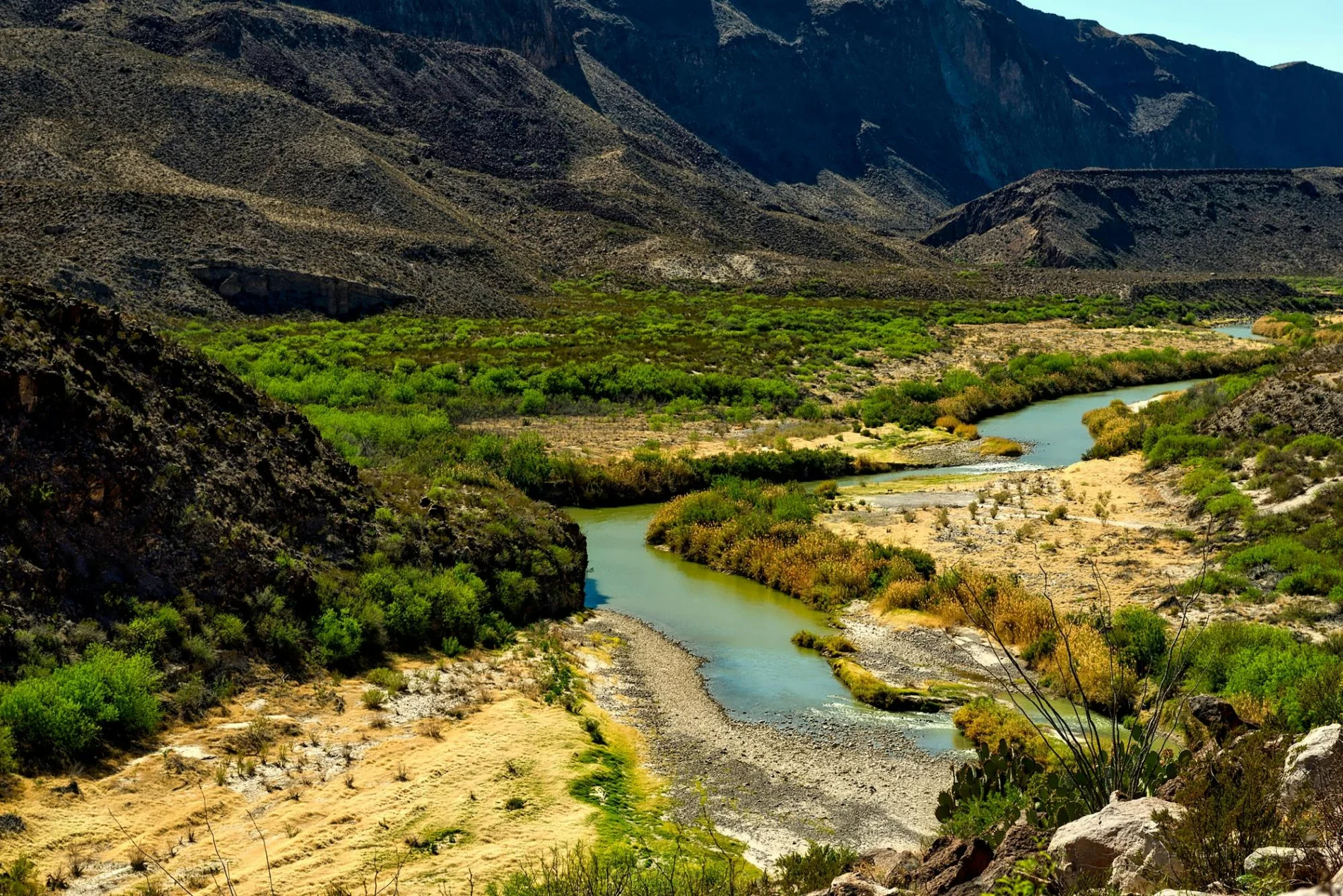 A stream of water cuts through a valley