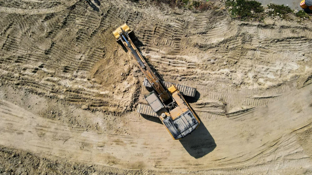 Birdseye view of heavy mining equipment on brown rock formation during daytime
