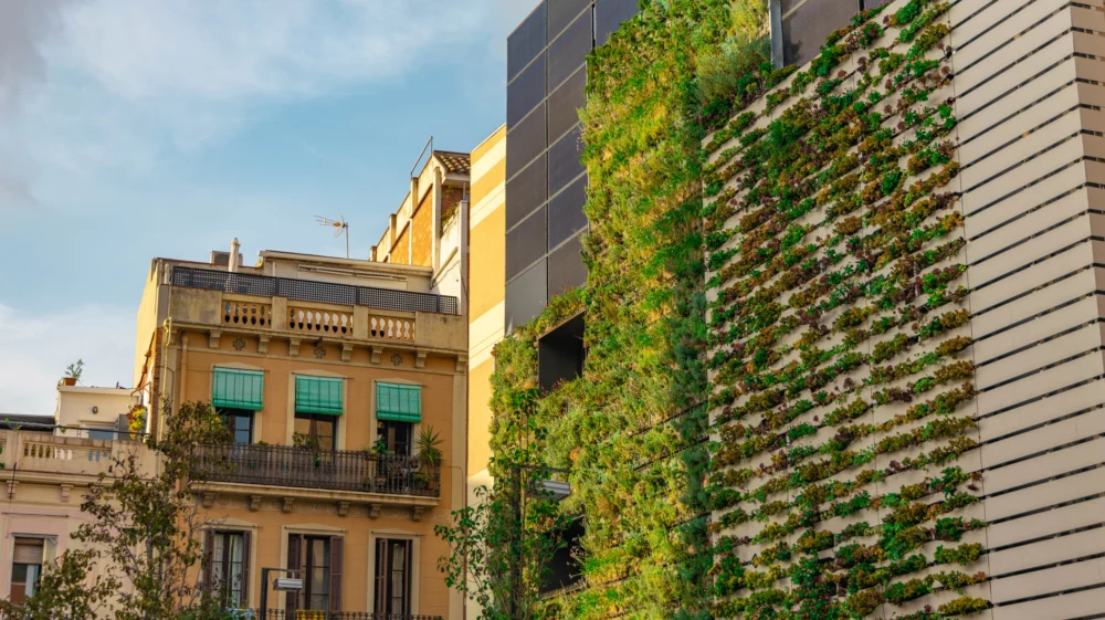 Sustainable building facade with a living wall and solar panels in the Barcelona city