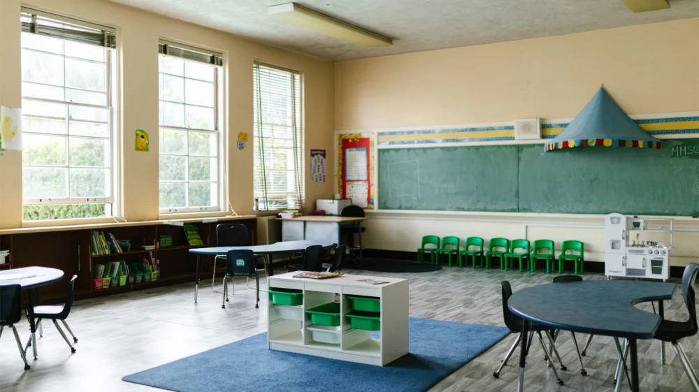 Empty school classroom with some windows open.
