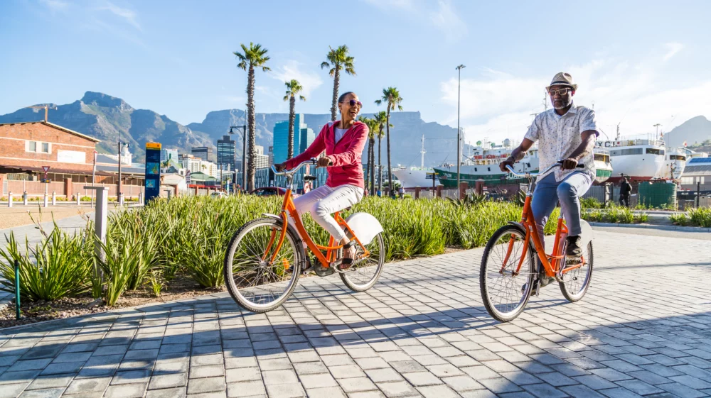 A man and woman riding on bicycles in Cape Town