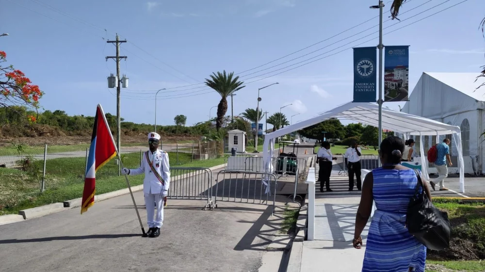 A flag guard stands at the entrance to the SIDS4 conference at the University of Antigua.