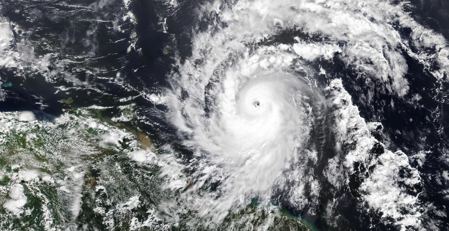 Satellite image of Hurricane Beryl approaching the Caribbean, showing a well-defined eye and extensive cloud bands.