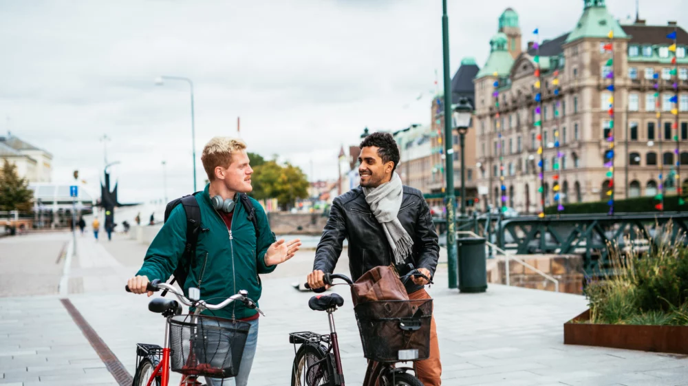 Gay couple riding bicycles in Malmö city