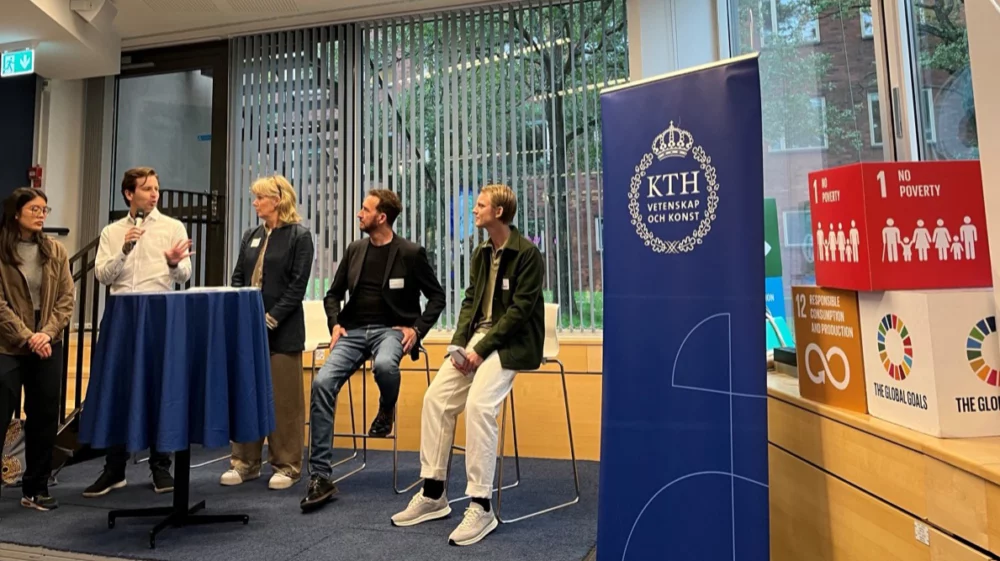 Five speakers stand on stage in front of a KTH Royal Institute of Technology banner. They are engaged in a panel discussion during the Maggan Hub outcomes workshop, with Global Goals icons displayed beside them.