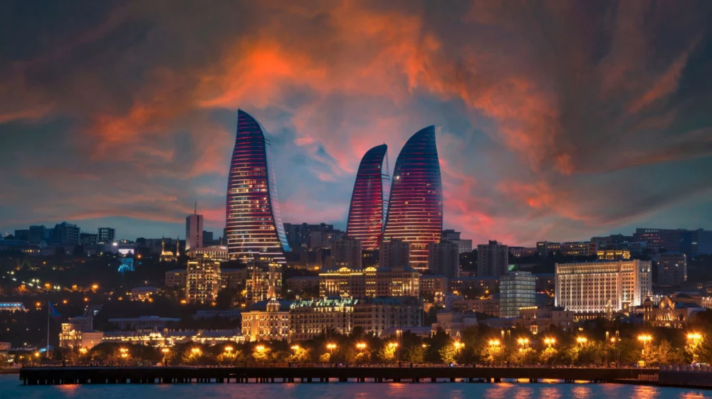 The Flame Towers and Caspian sea, seen from Baku Boulevard at sunset in Baku, Azerbaijan.