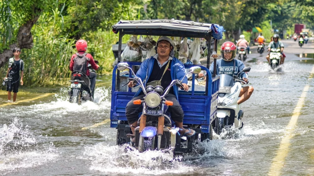 Several vehicles such as trucks, bicycles and cars were trapped by floodwater in Gresik Regency, Indonesia, 21 February 2024