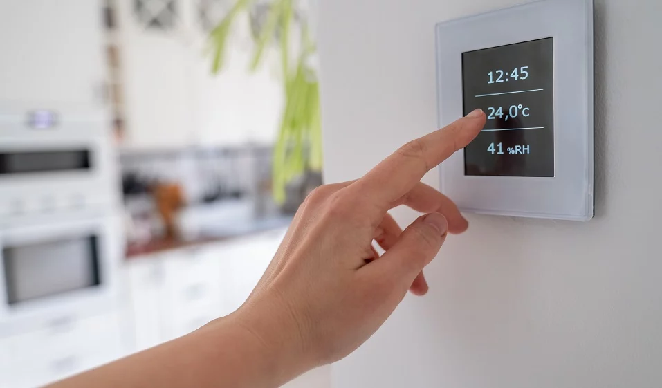 Hand using Air ventilation controller panel with display at home. Smart home system
