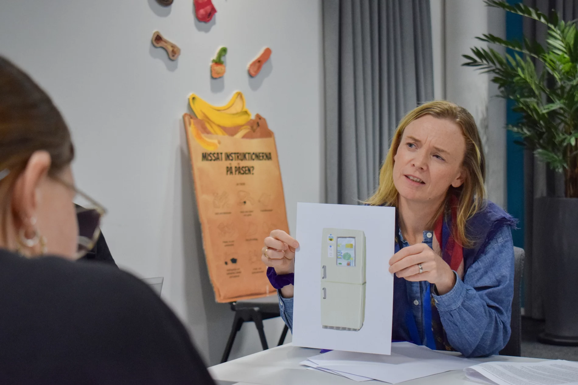 SEI Senior Research Fellow Fiona Lambe showing workshop participant an illustration of a fridge with a window and notes