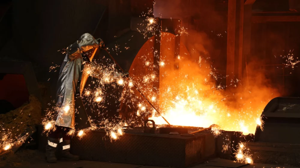 Sparks fly as a worker takes a sample of molten iron flowing from a blast furnace at the Thyssenkrupp Steel Europe steelworks on November 09, 2021 in Duisburg, Germany.