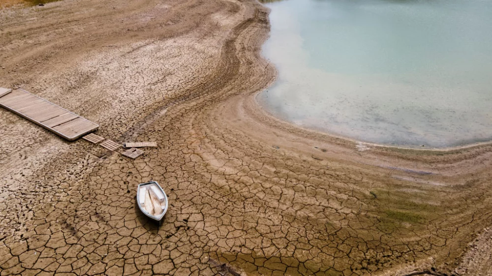 A nautical pass and a boat grounded on the cracked ground