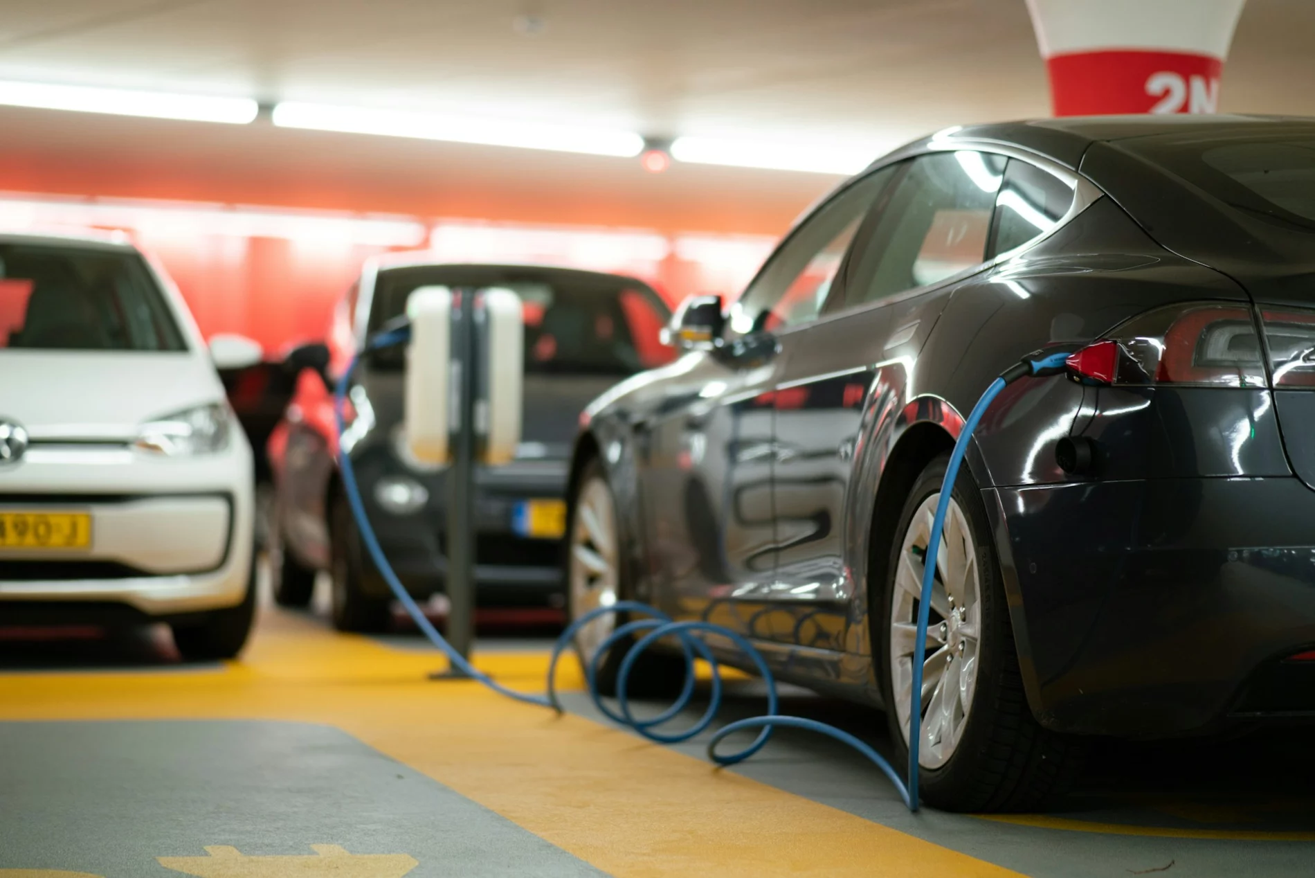 black and silver electric cars charging on parking lot