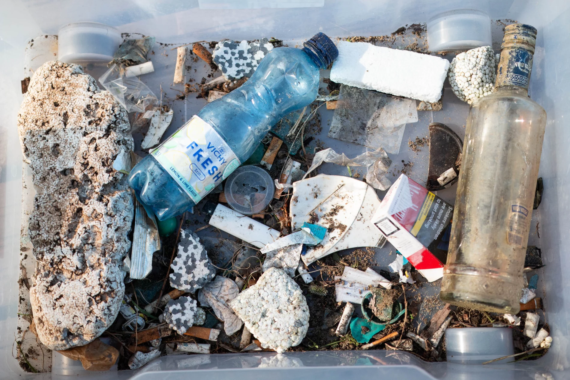 A box full of various trash from the river.