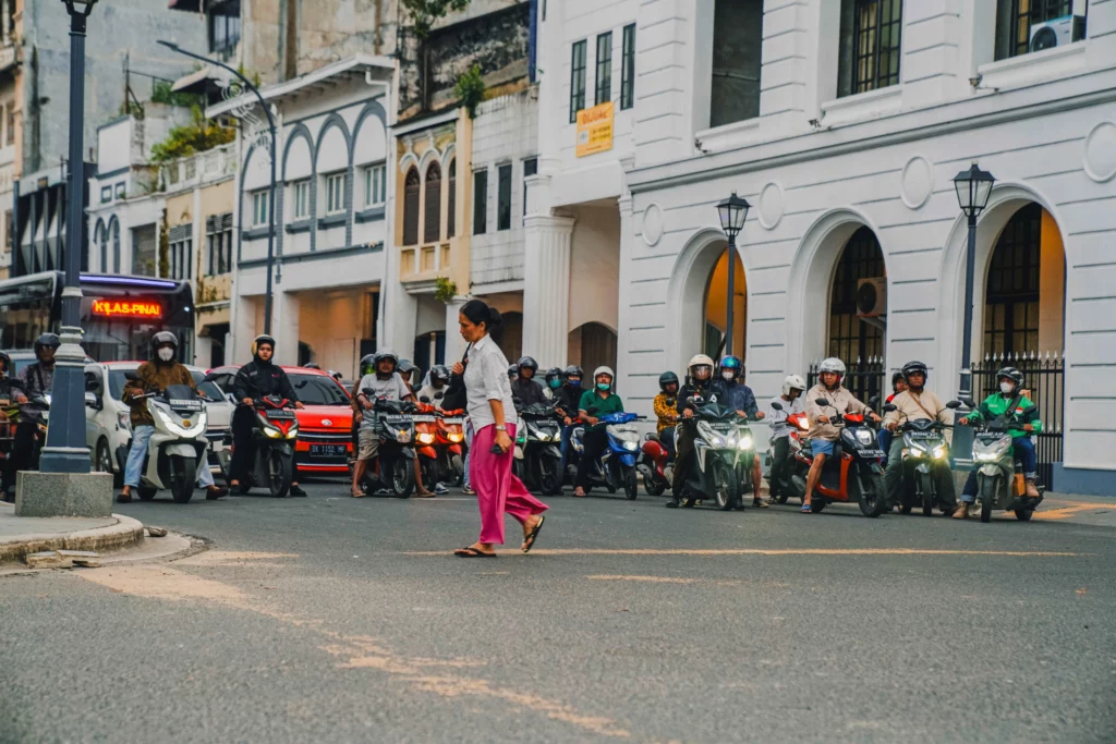 A pedestrian crossing an intersection in Medan.