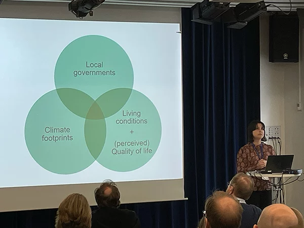 Karin André presenting a Venn diagram showing the intersection of climate footprints, local governments, and quality of life.