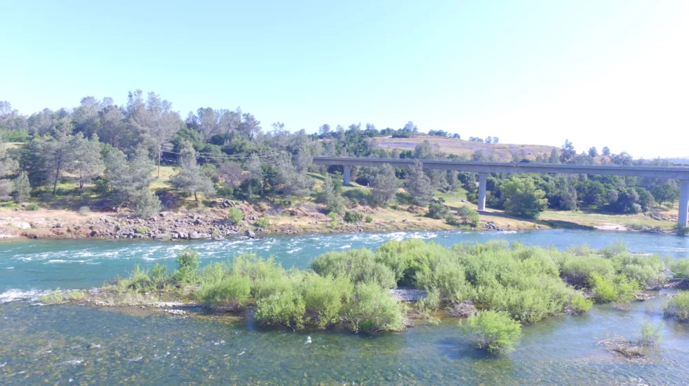 Yuba river with bridge under blue sky