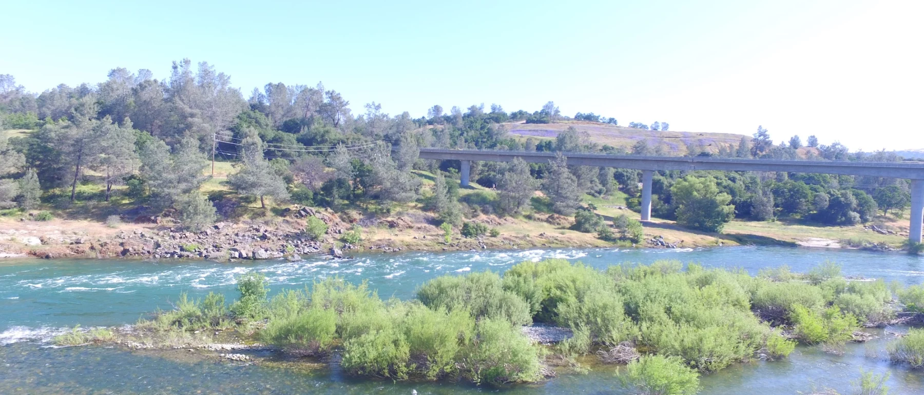 Yuba river with bridge under blue sky