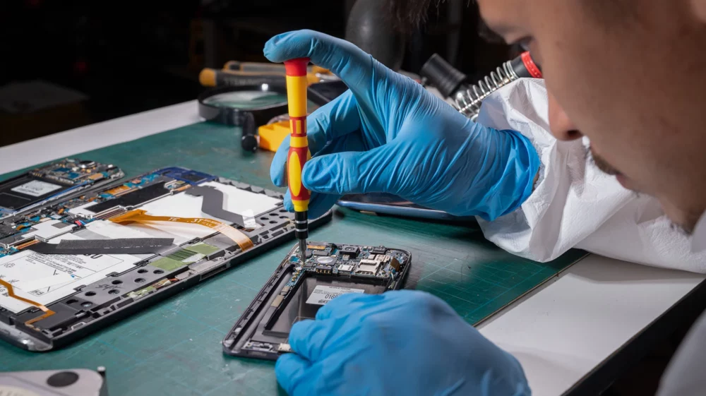 Technician repairing the smartphone in the laboratory