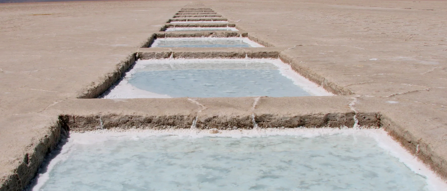 Identical rectangular pools extend in a row into the horizon in the high-desert salt flats of northwestern Argentina.