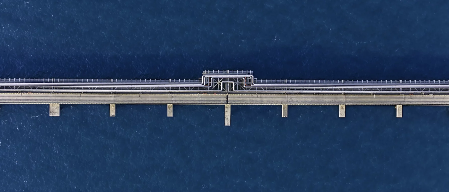 Pipe on top of deep blue water