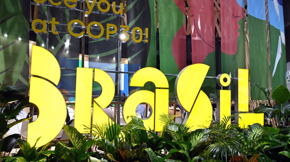 Large yellow “Brasil” sign surrounded by plants with “See you at COP30!” displayed in the background.