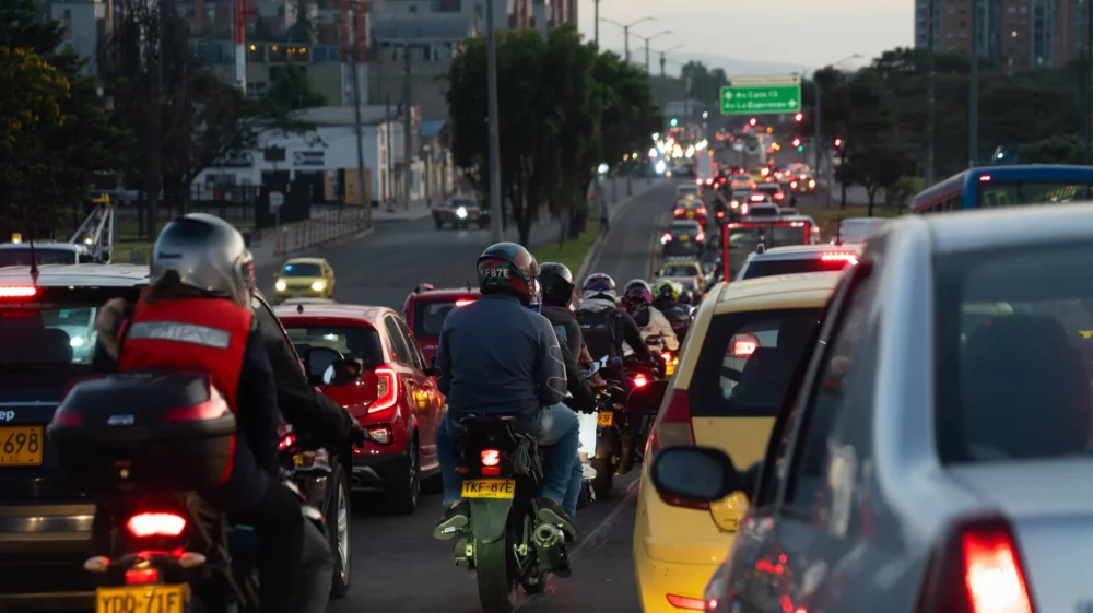 Evening traffic congestion with cars and motorbikes in a city.