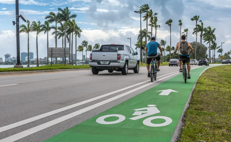 In Miami Beach, Florida, a green bike lane protects bikers as they bike alongside cars.