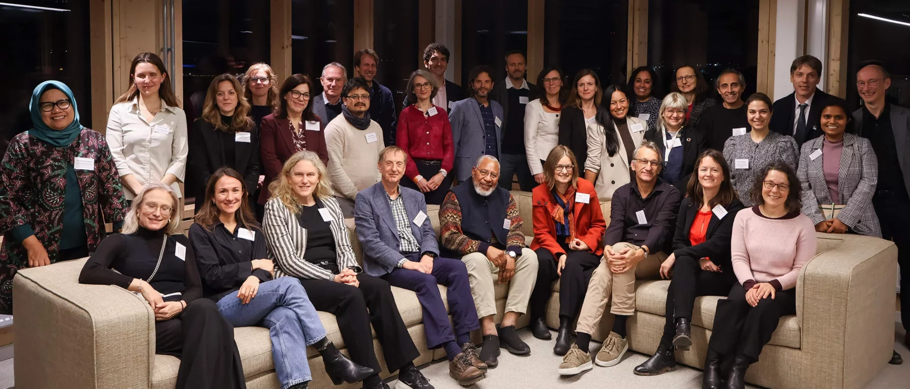 Group photo of researchers and policy experts gathered indoors at a workshop meeting.