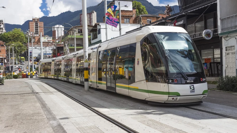 A tram in Medillin, Colombia with a backdrop of the city.