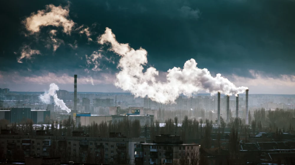 Aerial view of Kyiv buildings with steam coming our of chimneys of a city powerplant