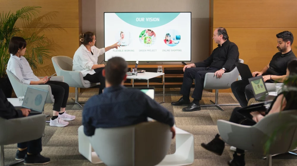 Group of business people gather together for business meeting and presentation