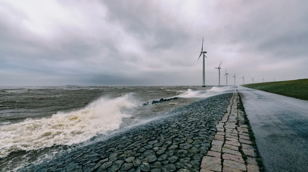 Wind turbines on land and offshore in a storm