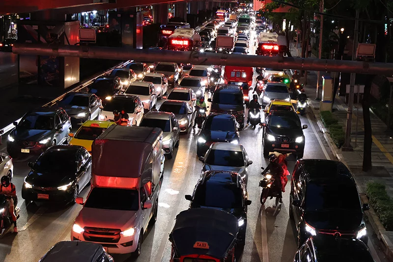 Rows of cars on a congested road at night.