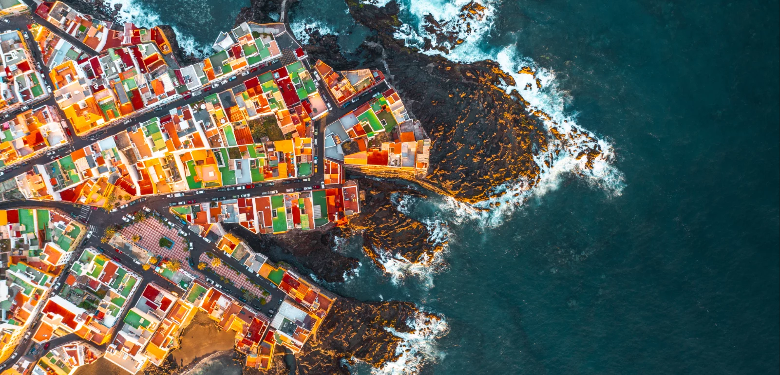 Aerial view of colorful houses on headland, Tenerife, Spain